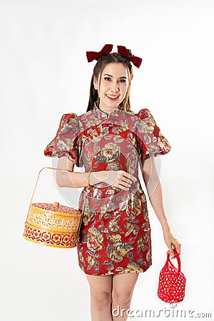Chinese New Year concept, Woman holding a basket of food and red basket ,meaning to be happy healthy and wealthy year, Chinese New Stock Photo