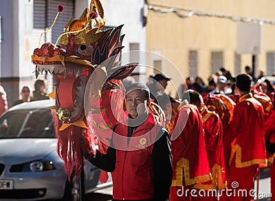 Chinese New Year parade in Usera neighborhood, Madrid. Spain. Traditional Chinese dragon carried by several people in traditional Editorial Stock Photo
