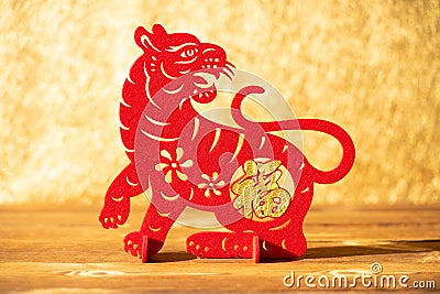 A Chinese New Year of tiger 2022 mascot paper cut on a wood table in the morning the Chinese means fortune no logo no trademark Stock Photo