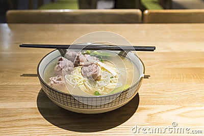 chinese noodles with Pork cartilage soup on wood table background Stock Photo