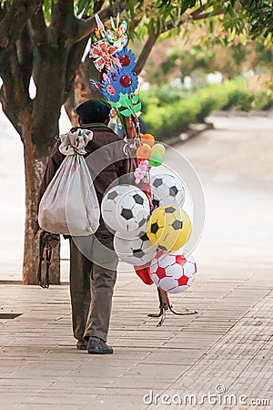 Chinese old man street vendor seller ball and other toys on the Editorial Stock Photo