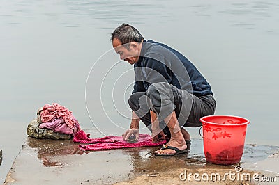 Chinese peasant man washes in the river, China Editorial Stock Photo
