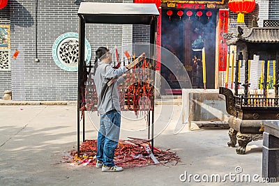 Chinese people buring the joss sticks and doing worship at the Chinese Guanyu temple in Nantou Ancient Town, Shenzhen, China Editorial Stock Photo