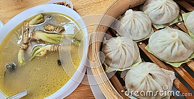 Chinese pork bun and black chicken soup. Stock Photo