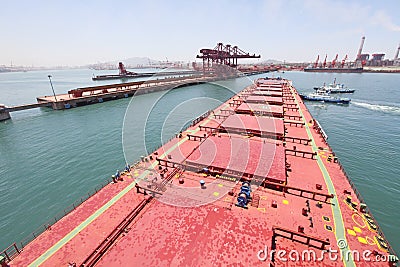 Into the Chinese port of Qingdao ore carriers Editorial Stock Photo