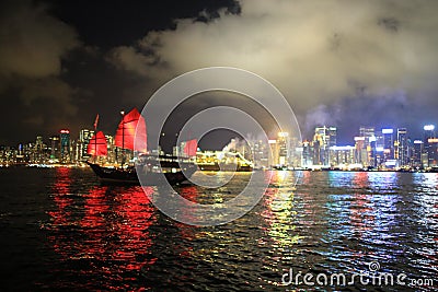 Chinese red junk with the victoria harbor night view background Stock Photo