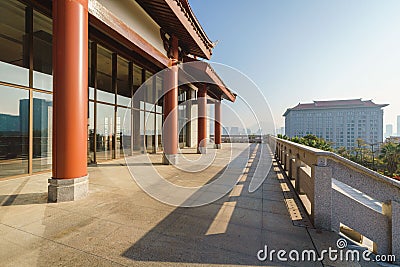 Chinese retro corridor and city skyline with red pillars under the sunlight Stock Photo