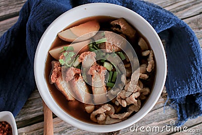 Chinese roll noodles soup with crispy pork and egg , noodle. Thai language called `Kuay Jab` and seasoning Chinese food. Stock Photo