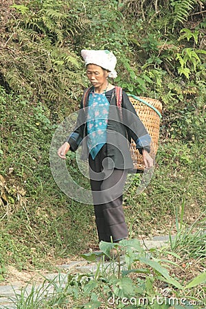 Chinese rural resident. Guilin Yangshuo. peasant woman with basket Editorial Stock Photo