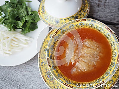 Chinese Shark`s Fin Soup with brown sauce serve in Royal yellow bowl. Stock Photo