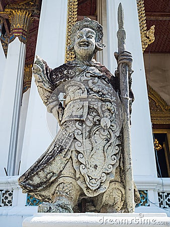 Chinese standing giant carved out of rock in Wat Suthat Thep War Stock Photo