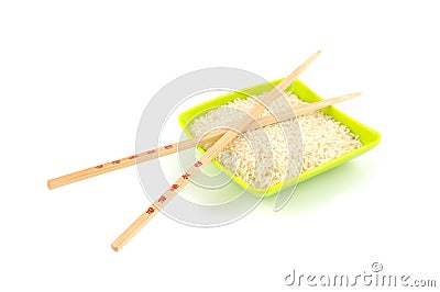 Chinese sticks on green bowl with rice Stock Photo