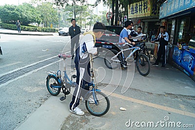 Chinese students riding a bicycle in the street Editorial Stock Photo