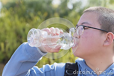 Chinese teen drinking water outdoor Stock Photo