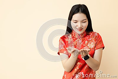 Chinese teen girl hand giving donation posture dressing traditional dress with space for text Stock Photo