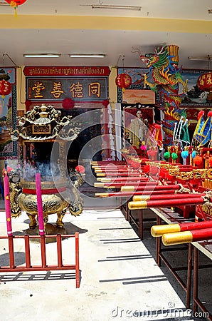 Chinese temple door flags joss urn and King portrait Pattani Thailand Editorial Stock Photo