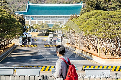 A Chinese tourist watching the Blue House, Chewongde, is the executive office and official residence of the President of the Editorial Stock Photo