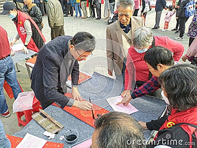 Chinese traditional custom: writing Spring Festival couplets Editorial Stock Photo