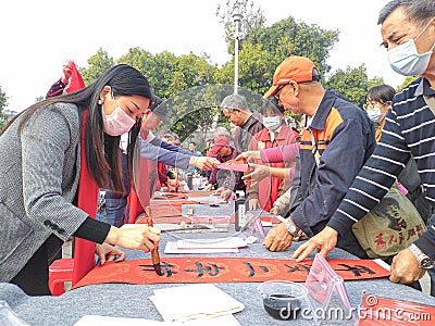 Chinese traditional custom: writing Spring Festival couplets Editorial Stock Photo