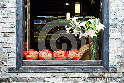 Chinese wine fermented with osmanthus flowers in traditional va Stock Photo