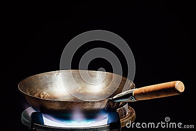 Chinese wok pan on fire gas burner Stock Photo