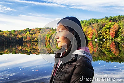 Chinese woman looking at the morning sun in autumn Stock Photo
