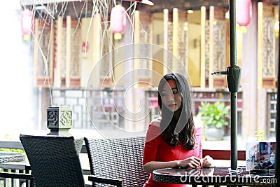 A Chinese woman in red dress in Feng Jing ancient town Stock Photo