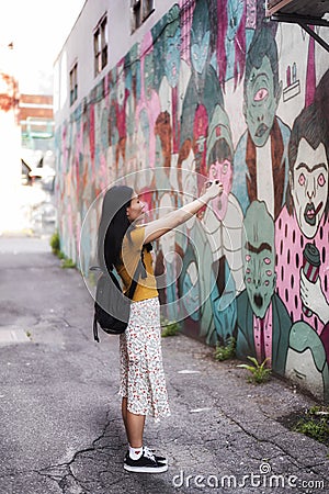 Chinese woman taking pictures of graffiti montreal Editorial Stock Photo