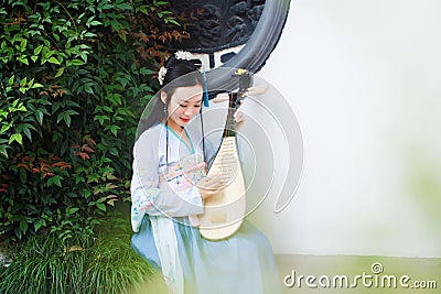 Chinese woman in traditional Hanfu dress,play traditional instrument of pipa Stock Photo