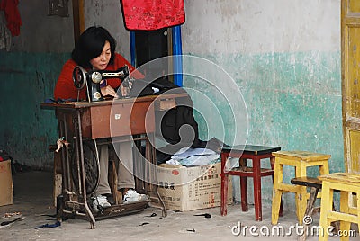 Chinese Woman at Work in a Garments Shop Editorial Stock Photo