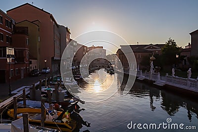 Chioggia - Collection of ancient statues graces peaceful water canal in the charming town of Chioggia Stock Photo