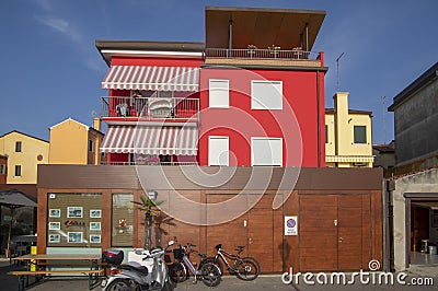 Chioggia, ITALY - June 4, 2022: Pictoresque streets of old town Sottomarina, colorful buldings in sunlight, blue sky Editorial Stock Photo