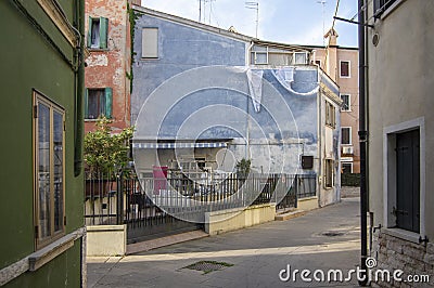 Chioggia, ITALY - June 4, 2022: Pictoresque streets of old town Sottomarina, colorful buldings in sunlight, blue sky Editorial Stock Photo