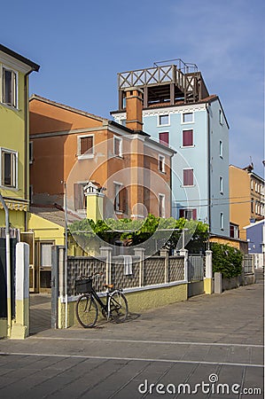 Chioggia, ITALY - June 4, 2022: Pictoresque streets of old town Sottomarina, colorful buldings in sunlight, blue sky Editorial Stock Photo