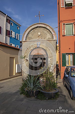 Chioggia, ITALY - June 4, 2022: Pictoresque streets of old town Sottomarina with small chapel, colorful buldings in sunny day Editorial Stock Photo