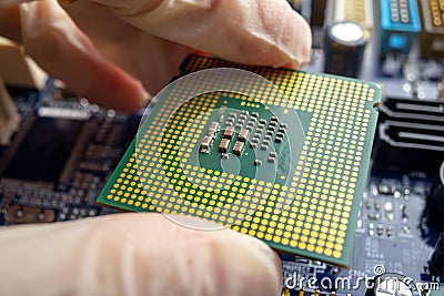 Chip microprocessor in the hands of an engineer technician for the computers. High technology and repair microchip Stock Photo