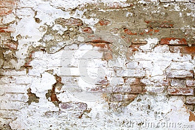 Chipped, peeling white paint on the old red brick wall. Stock Photo