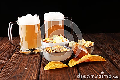 Chips, salty snacks, football and Beer on a table. Great for Bowl Game projects Stock Photo