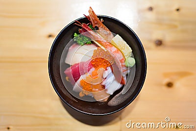 Chirashi sushi, Japanese food rice bowl with raw salmon sashimi, tuna, and other mixed seafood, top view, center aligned with copy Stock Photo