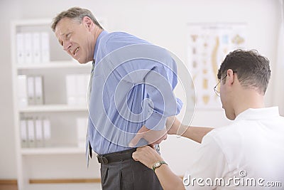 Chiropractic: Chiropractor examining senior man. Stock Photo