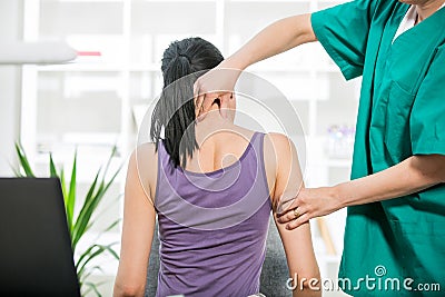 Chiropractor adjusting neck muscles to female Stock Photo