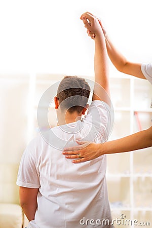 Chiropractor doing adjustment on male patient. Selective focus Stock Photo