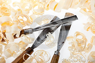 Chisels and wood shavings on white background Stock Photo