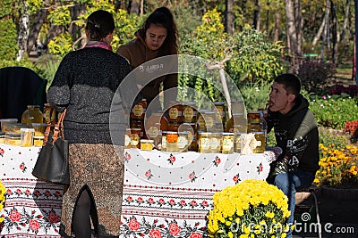 Chisinau, Moldova - October 15, 2022: Lots of different Polish branded honey glass jars. woman buying honey Editorial Stock Photo