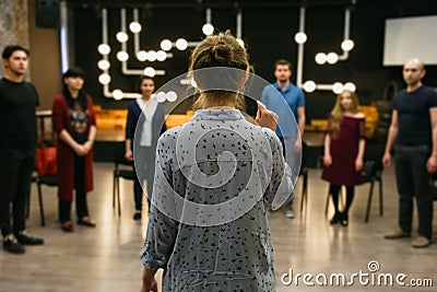 Chisinau, Republic of Moldova - April 30, 2018: Teacher of acting or business coach stands back in front of a group of students. Editorial Stock Photo