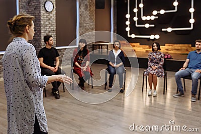 Chisinau, Republic of Moldova - April 30, 2018: Teacher of acting or business coach stands back in front of a group of students. Editorial Stock Photo
