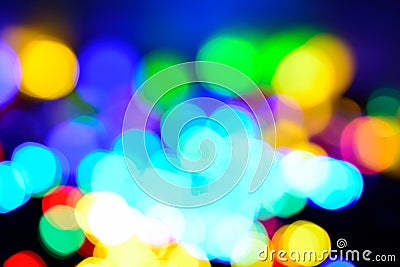 Chistmas background with coloutful bokeh in light and dark blue, yellow, orange, green, purple. Defocused Stock Photo