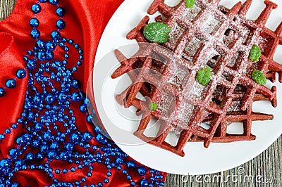 Chocolate American waffles `Red velvet` on a white ceramic plate Stock Photo