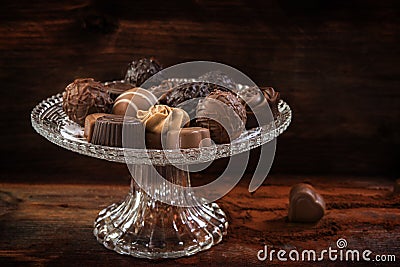 Chocolate, assortment of pralines on an elegant glass Ã©tagÃ¨re Stock Photo