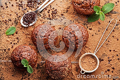 Chocolate banana muffin on cocoa background top view. Delicious homemade bakery. Stock Photo